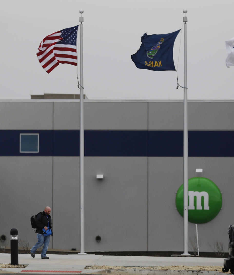 A man walks out the entrance of the new Mars Inc. production facility near Topeka, Kan., Wednesday, March 26, 2014. It's the company's first new North American production facility in 35 years. (AP Photo/Orlin Wagner)