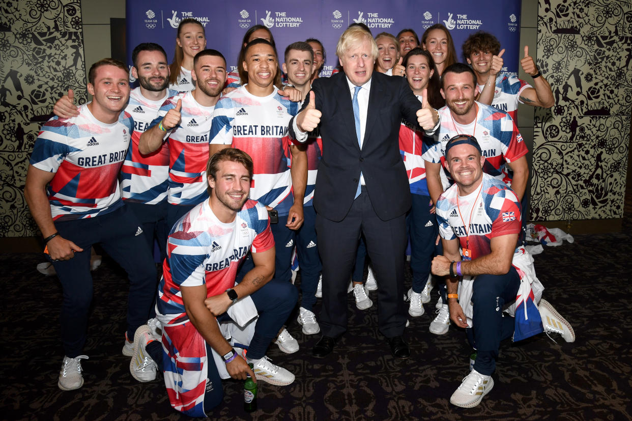 LONDON, ENGLAND - AUGUST 15: Prime Minister, Boris Johnson poses with Olympians during The National Lottery's Team GB homecoming event at Hilton London Wembley on August 15, 2021 in London, England. (Photo by Gareth Cattermole/Getty Images for The National Lottery)