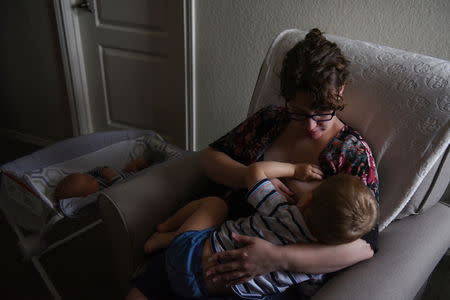 Lauren Hoffmann, 29, a college program manager, nurses her two-year old son Asa while her baby Micah sleeps beside her in San Antonio, Texas, U.S., February 7, 2019. REUTERS/Callaghan O'Hare