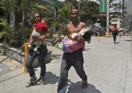 <p>Una familia corre con sus hijos para huir de los efectos del gas lacrimógeno disparado por la Policía Nacional Bolivariana durante una protesta en Caracas, Venezuela, el lunes 10 de abril de 2017. (AP / Fernando Llano)</p>