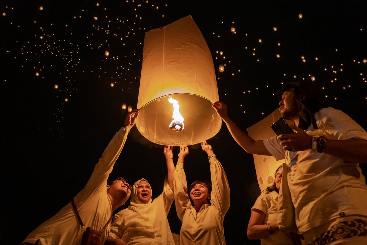 Buddhist devotees and tourists release a lantern into the air on Borobudur temple in Central Java, Indonesia (Ulet Ifansasti / Getty Images)