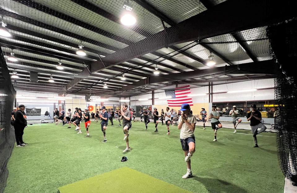 Members of the Aztec High School baseball team take part in yoga classes at the Strike Zone in Farmington while waiting out a weather delay in the Scorpion Invitational Tournament, Thursday, March 16, 2023.