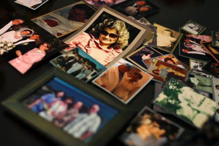 Darlene Coker is shown on a kitchen table full of many personal pictures of her family life in California, U.S. August 15, 2018. Picture taken August 15, 2018. REUTERS/Mike Blake