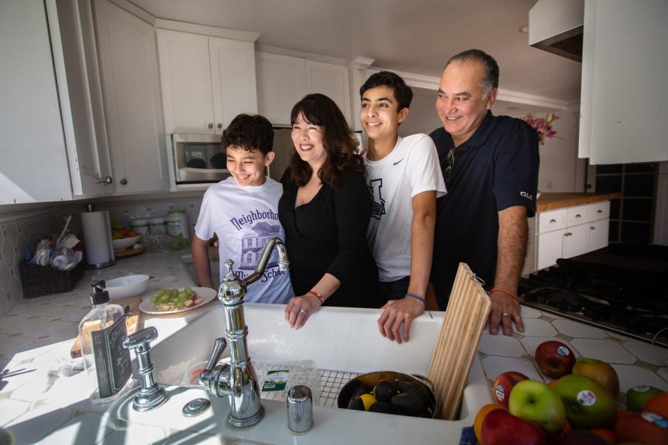 Benjamin and Sebastian Hernandez at home with mother Margaret and father Alex.