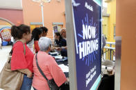 FILE - In this Oct. 1, 2019, file photo people wait in line to inquire about job openings with Marshalls during a job fair at Dolphin Mall in Miami. On Friday, Dec. 6, the U.S. government issues the November jobs report. (AP Photo/Lynne Sladky, File)