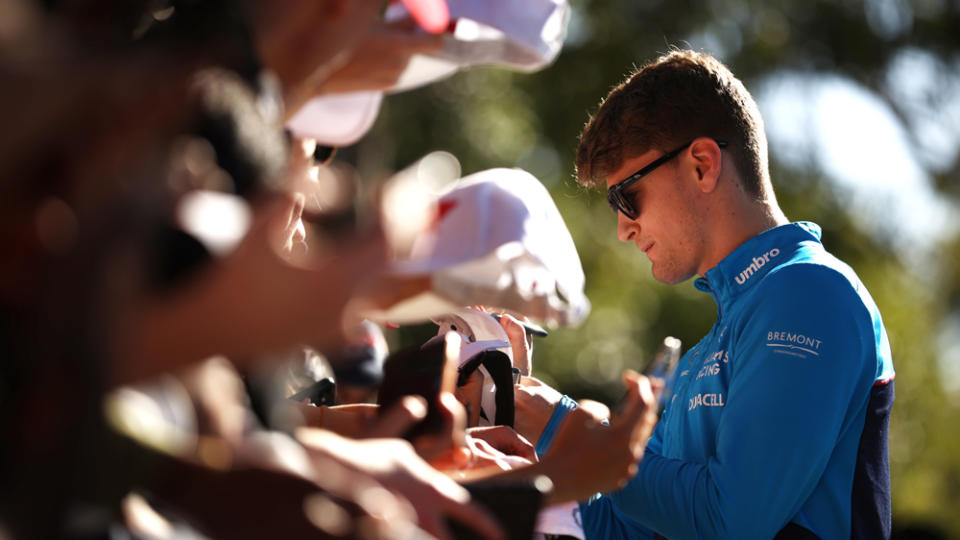 Sargeant signing autographs before the 2023 Australian Grand Prix.