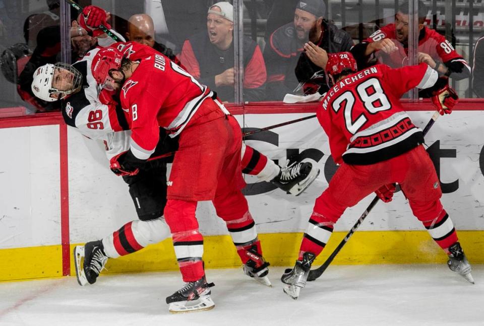 The Carolina Hurricanes Brent Burns (8) checks the New Jersey Devils Timo Meier (96) into the boards in the second period during Game 5 of their second round Stanley Cup playoff series on Thursday, May 11, 2023 at PNC Arena in Raleigh, N.C.