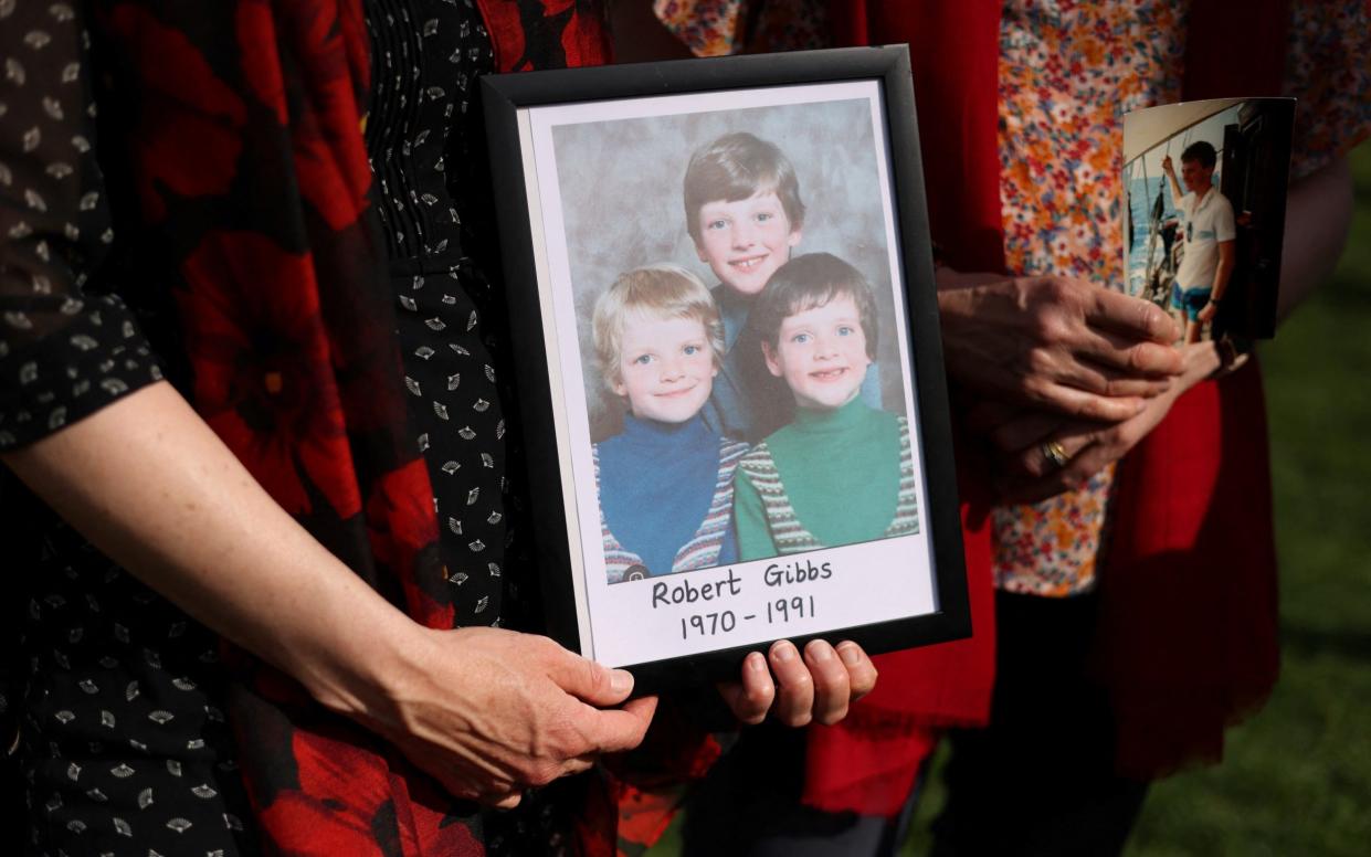 Women hold a picture of their brother Robert Gibbs, a victim of the blood scandal who was nine years old when he was infected with contaminated blood products, contracted HIV and Hepatitis C and died aged twenty one, as they gather in Westminster for a vigil, in London, Britain, May 19, 2024.