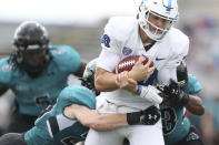 Buffalo quarterback Matt Myers (10) breaks tackles by Coastal Carolina safety Brayden Matts, left, and Jacob Proche, right, to score a touchdown during the first half of a NCAA college football game in Buffalo, N.Y. on Saturday, Sept. 18, 2021. (AP Photo/Joshua Bessex)