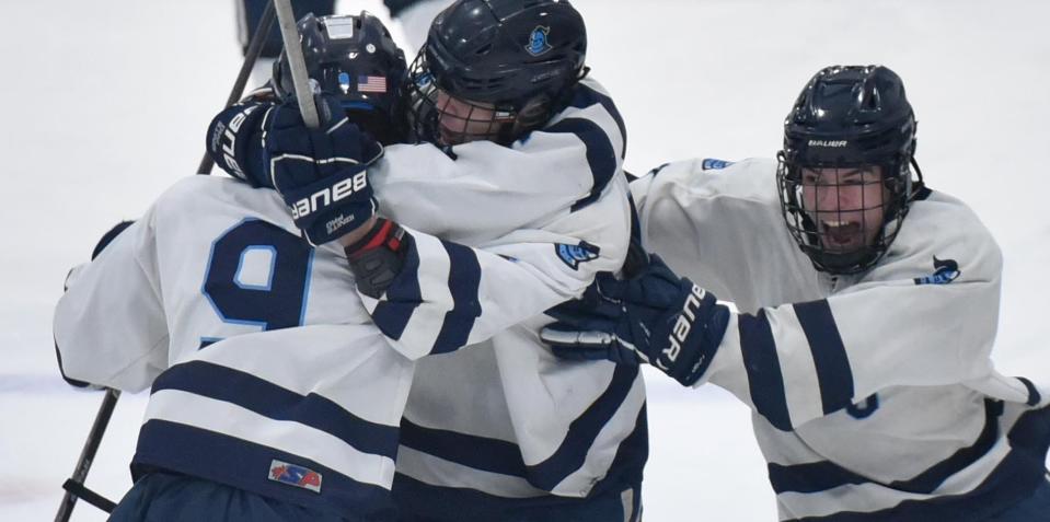 Sandwich's Avery Richardson, left, is swarmed by teammates after their second goal in the first period as Dennis-Yarmouth/Cape Cod Tech/Cape Cod Academy and Sandwich met in tournament hockey action at Gallo Arena on Thursday night.