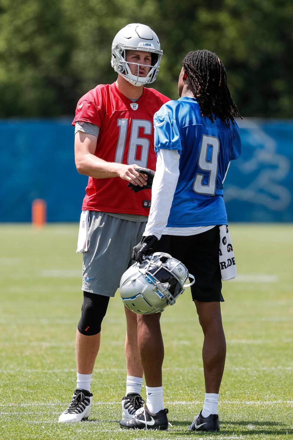 Detroit Lions quarterback Jared Goff (16) talks with wide receiver Jameson Williams (9) during OTAs at Detroit Lions headquarters in Allen Park on Thursday, June 1, 2023.