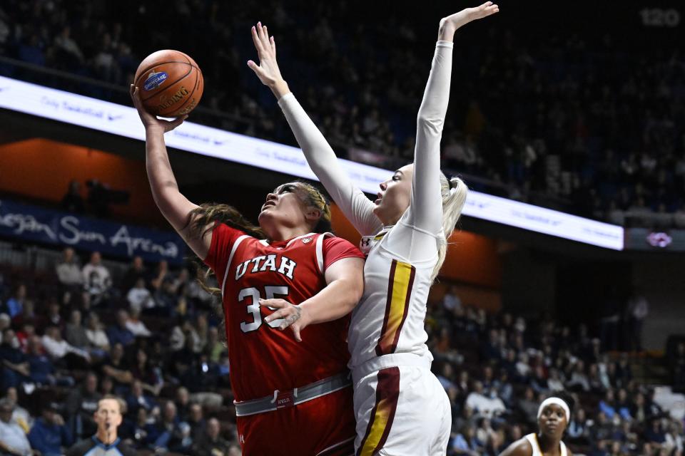 Utah forward Alissa Pili (35) shoots as South Carolina forward Chloe Kitts, center right, defends in the second half of an NCAA college basketball game, Sunday, Dec. 10, 2023, in Uncasville, Conn. | Jessica Hill, Associated Press
