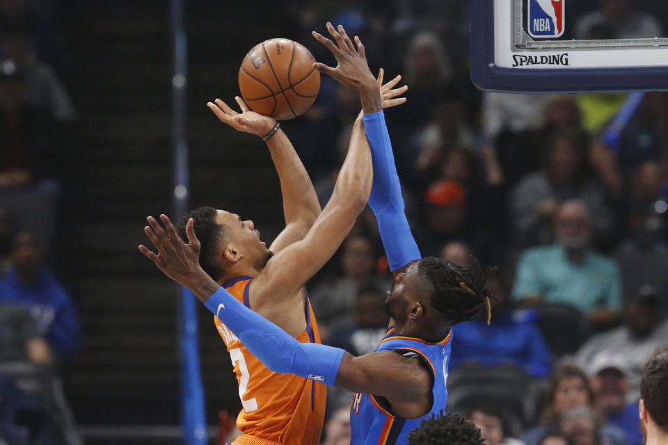 Phoenix Suns forward Elie Okobo (2) shoots as Oklahoma City Thunder center Nerlens Noel defends during the first half of an NBA basketball game Friday, Dec. 20, 2019, in Oklahoma City. (AP Photo/Sue Ogrocki)