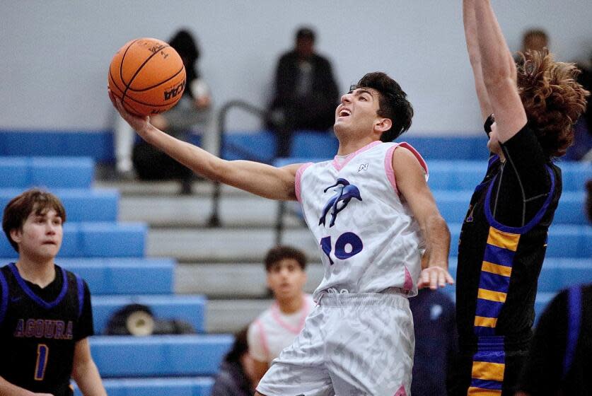 Jordan Farhadian drives for a layup in Saturday's intersectional victory over Agoura, the Dolphins' fourth win in a row.