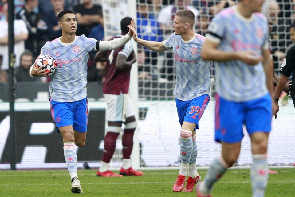 Manchester United's Cristiano Ronaldo, left, celebrates after scoring his side's first goal during the English Premier League soccer match between West Ham United and Manchester United at the London Stadium in London, England, Sunday, Sept. 19, 2021. (AP Photo/Ian Walton)