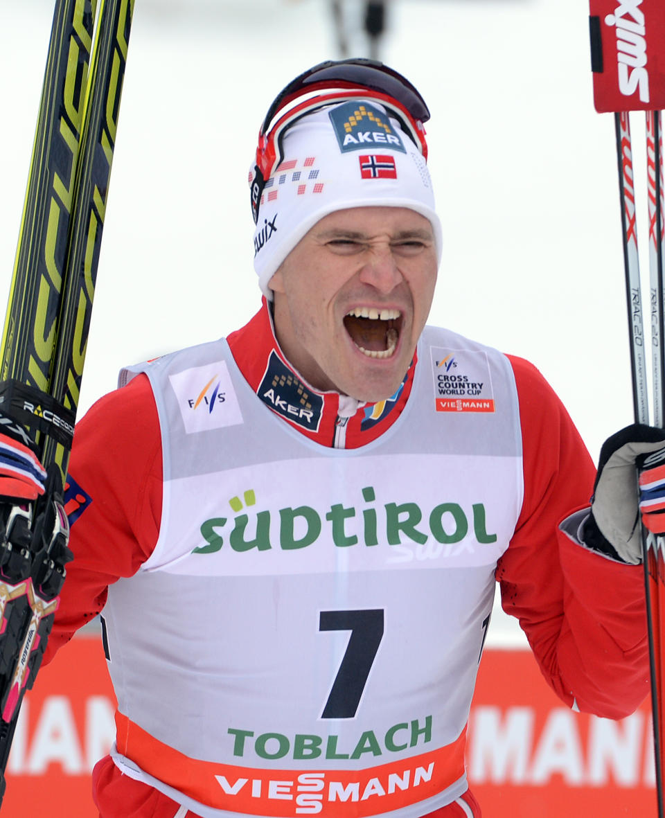 Winner Ola Vigen Hattestad of Norway celebrates after crossing the finish line of a cross country men's World Cup sprint, in Dobbiaco, Italy, Sunday, Feb. 2, 2014. (AP Photo/Elvis Piazzi)