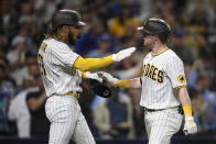 San Diego Padres' Jake Cronenworth, right, is congratulated by Fernando Tatis Jr. after Cronenworth hit a two-run home run in the fifth inning of a baseball game against the Los Angeles Dodgers, Monday, June 21, 2021, in San Diego. (AP Photo/Denis Poroy)