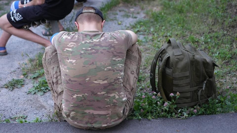 A wounded Ukrainian soldier rests on his way from the front.