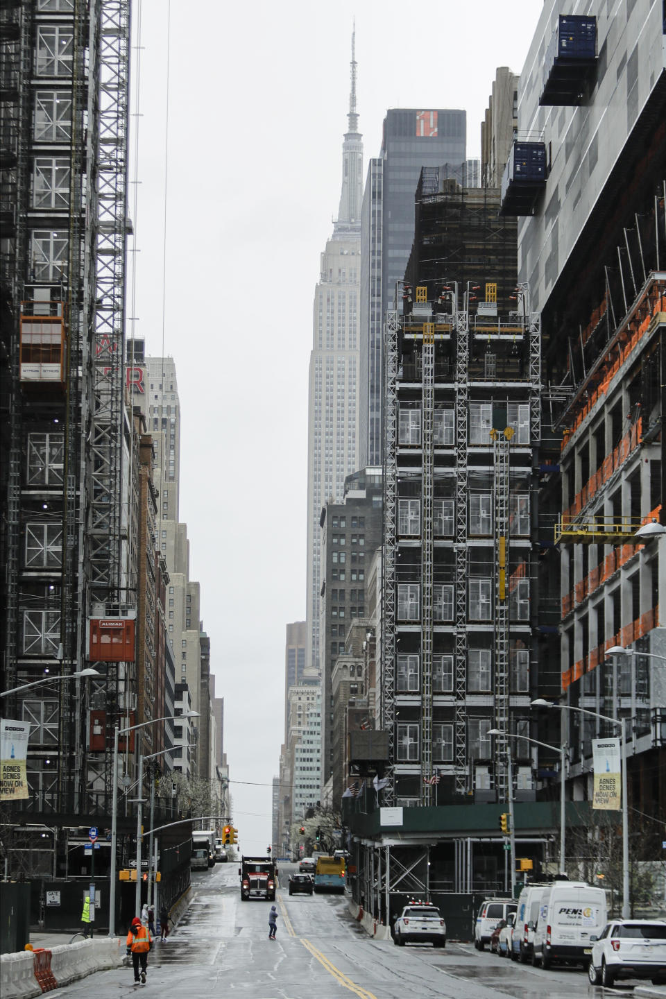 Pedestrians cross 34th Street Friday, April 3, 2020, in New York. The new coronavirus causes mild or moderate symptoms for most people, but for some, especially older adults and people with existing health problems, it can cause more severe illness or death. (AP Photo/Frank Franklin II)