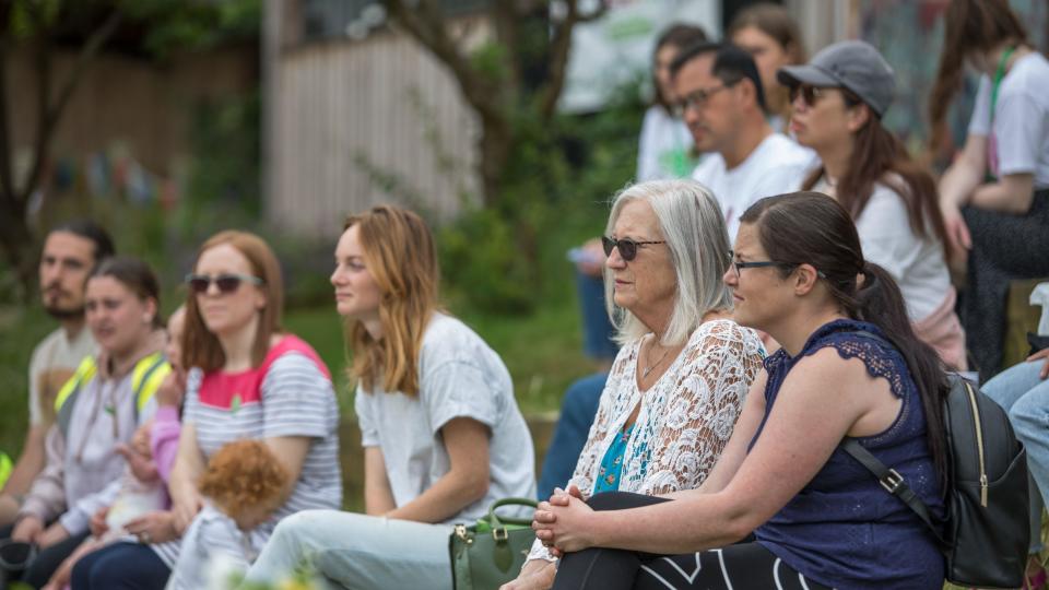 A crowd of people sitting down and listening to a talk on sustainable food and food waste