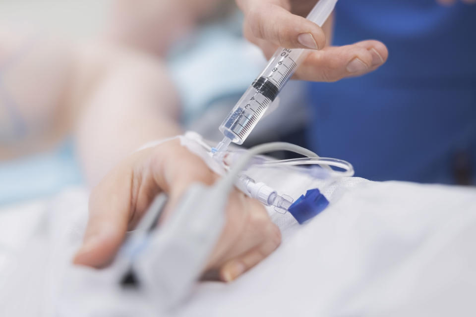 a doctor putting anesthesia into someone's hand