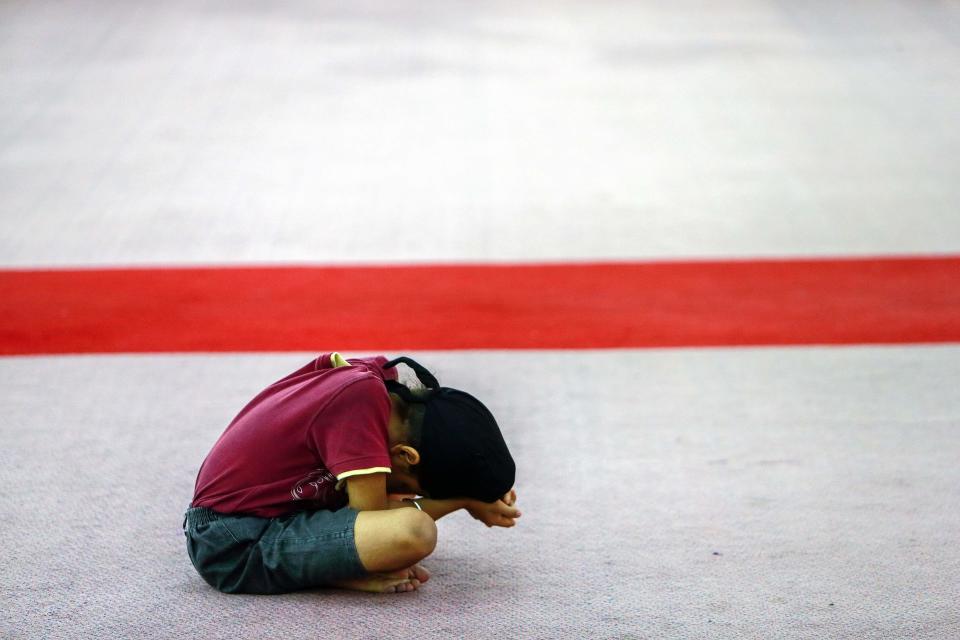 A child prays during a special prayer for passengers onboard the missing Malaysia Airlines Flight MH370 inside the Sikh temple in Kuala Lumpur