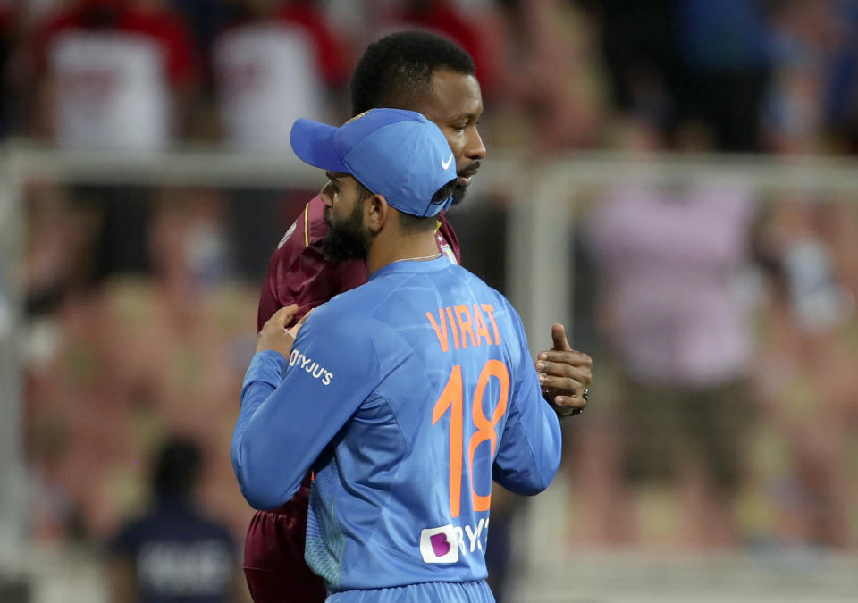 West Indies' captain Kieron Pollard, rear, hugs India's captain Virat Kohli after their win in the second Twenty20 international cricket match between India and West Indies in Thiruvanathapuram, India, Sunday, Dec. 8, 2019. (AP Photo/Aijaz Rahi)