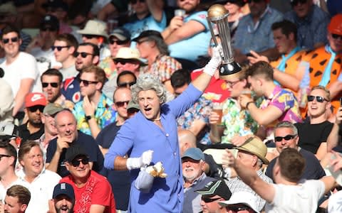 A fan dressed as The Queen in the stands - Credit: PA