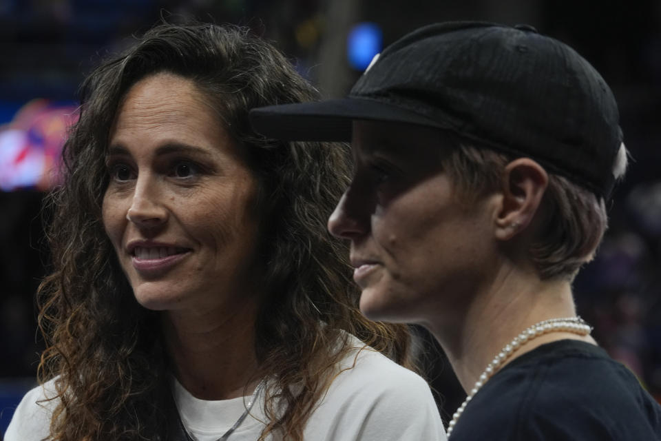 Former Women's National Basketball Association player Sue Bird, left, and her partner, soccer star Megan Rapinoe, speak after a WNBA basketball game between the Indiana Fever and Chicago Sky, Friday, Aug. 30, 2024, in Chicago. The Indiana Fever won 100-81. (AP Photo/Erin Hooley)