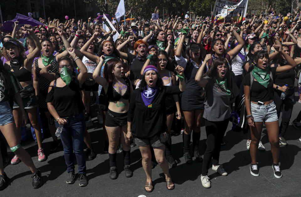 Women perform the feminist hymn "A rapist in your path," during the International Women's Day strike in Santiago, Chile, Monday, March 9, 2020. (AP Photo/Esteban Felix)