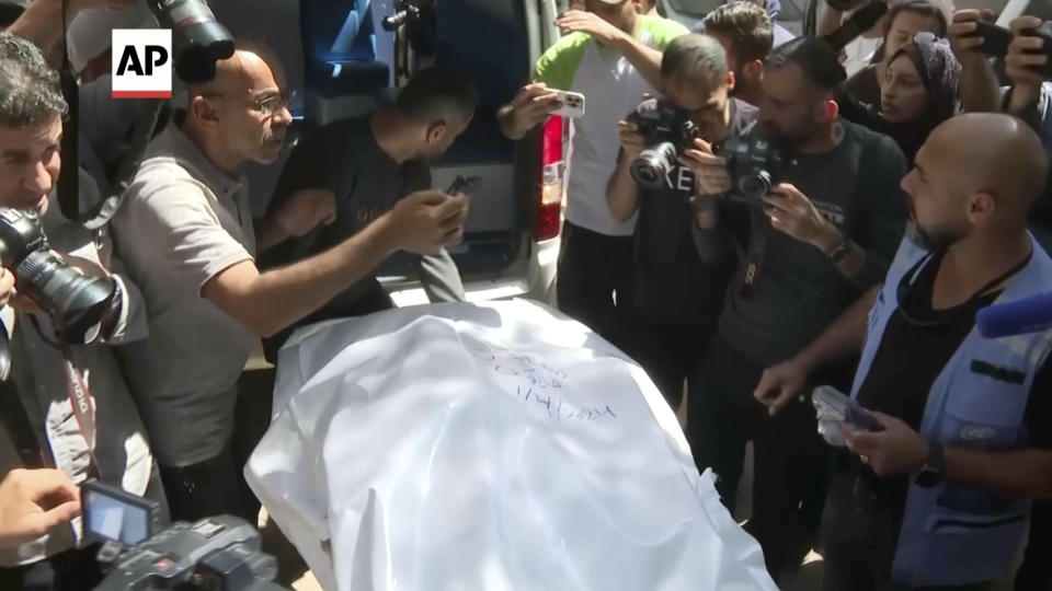 In this screen grab taken from video, the body of one of the six foreign aid workers killed in Israeli strikes is loaded into an ambulance in Gaza, Wednesday April 3, 2024. The bodies of six foreign aid workers killed in a series of Israeli strikes were transported out of the Gaza Strip and into Egypt on Wednesday ahead of their repatriation, Egypt's state-run Qahera TV reported. (AP Video)