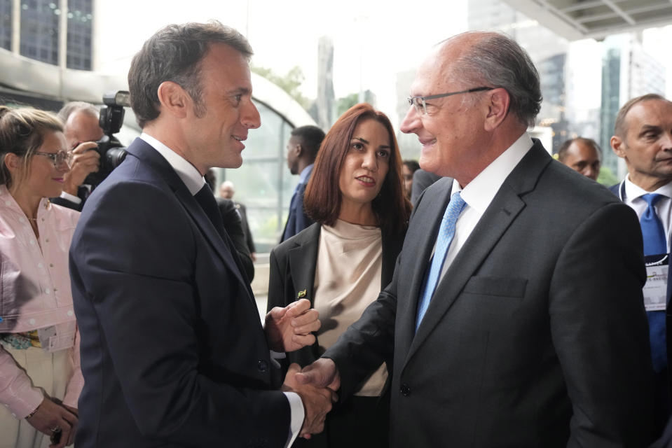 France's President Emmanuel Macron, left, shakes hands with Brazil's Vice President Geraldo Alckmin as ge arrives for a meeting with businesspeople at the Sao Paulo State Industries Federation (FIESP) in Sao Paulo, Brazil, Wednesday, March 27, 2024. Macron is on a three-day official visit to Brazil. (AP Photo/Andre Penner)