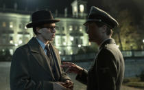 This image released by Netflix shows Jannis Niewohner as Paul Hartman, left, and August Diehl as Franz Sauer in a scene from "Munich: The Edge of War." (Frederic Batier/Netflix via AP)