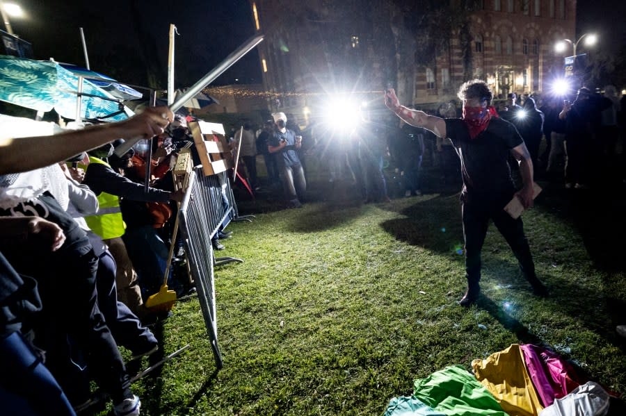 Counter protesters attack a pro-Palestinian encampment set up on the campus of the University of California Los Angeles (UCLA) as clashes erupt, in Los Angeles on May 1, 2024. Clashes broke out on May 1, 2024 around pro-Palestinian demonstrations at the University of California, Los Angeles, as universities around the United States struggle to contain similar protests on dozens of campuses. (Photo by ETIENNE LAURENT / AFP) (Photo by ETIENNE LAURENT/AFP via Getty Images)