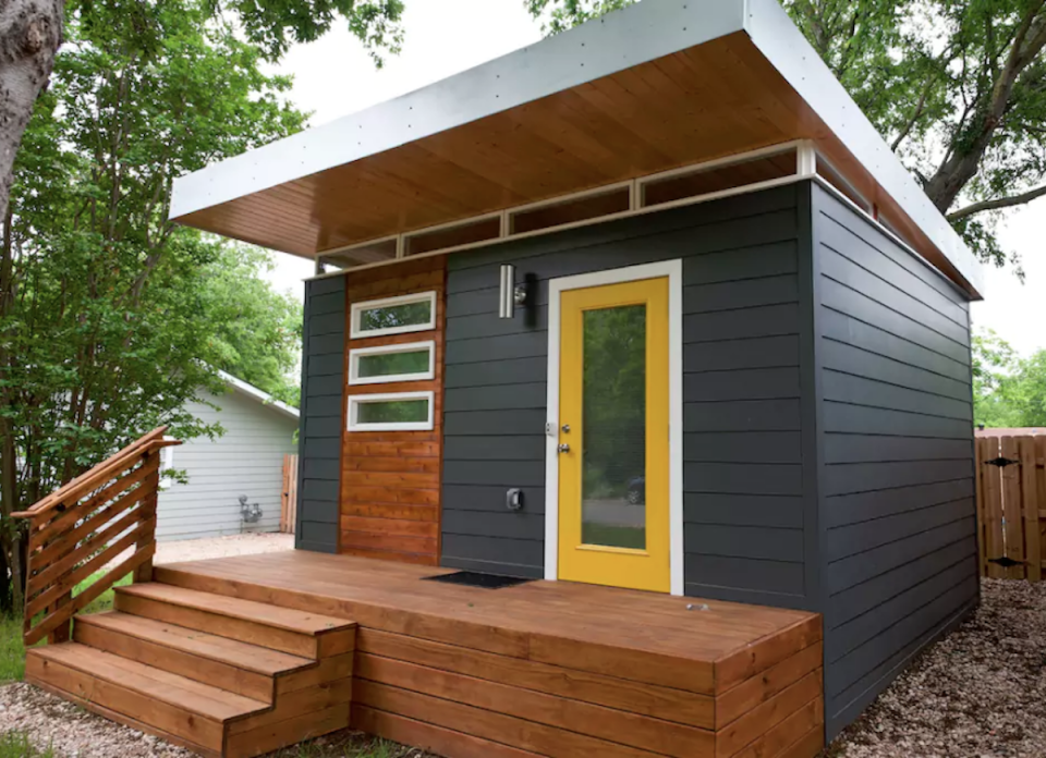 <body> <p>This tiny home for two makes a big statement with its appealing colors and clean lines. A stellar example of studio living for the minimalist-minded, the interior squeezes in an efficiency kitchen with fridge, cooktop, and microwave, while outside, a sunny yellow door, industrial-style awning, and <a rel="nofollow noopener" href=" http://www.bobvila.com/slideshow/18-inspiring-ideas-for-easy-outdoor-entertaining-50204?#.WD-yZKIrKRs?bv=yahoo" target="_blank" data-ylk="slk:raised porch;elm:context_link;itc:0;sec:content-canvas" class="link ">raised porch</a> are just perfect for sunbathing on balmy Austin afternoons.</p> <p><strong>Related: <a rel="nofollow noopener" href=" http://www.bobvila.com/slideshow/get-away-10-breathtaking-homes-you-can-rent-for-a-weekend-47684?#.WD-sX6IrKRs?bv=yahoo" target="_blank" data-ylk="slk:Get Away! 10 Breathtaking Homes You Can Rent for a Weekend;elm:context_link;itc:0;sec:content-canvas" class="link ">Get Away! 10 Breathtaking Homes You Can Rent for a Weekend</a> </strong> </p> </body>