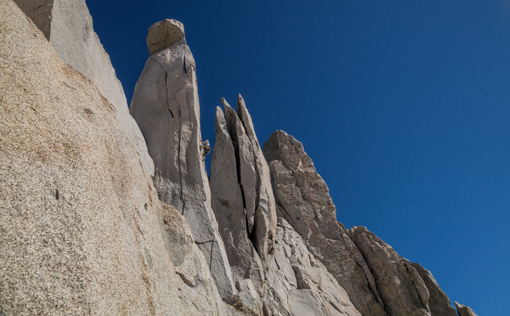 Christian "Mono" Gallardo climbs to a pointy subsummit of Cerro Torrecillas, deep in the remote heart of Hacienda Pucheguin, high above the Cochamo Valley. 