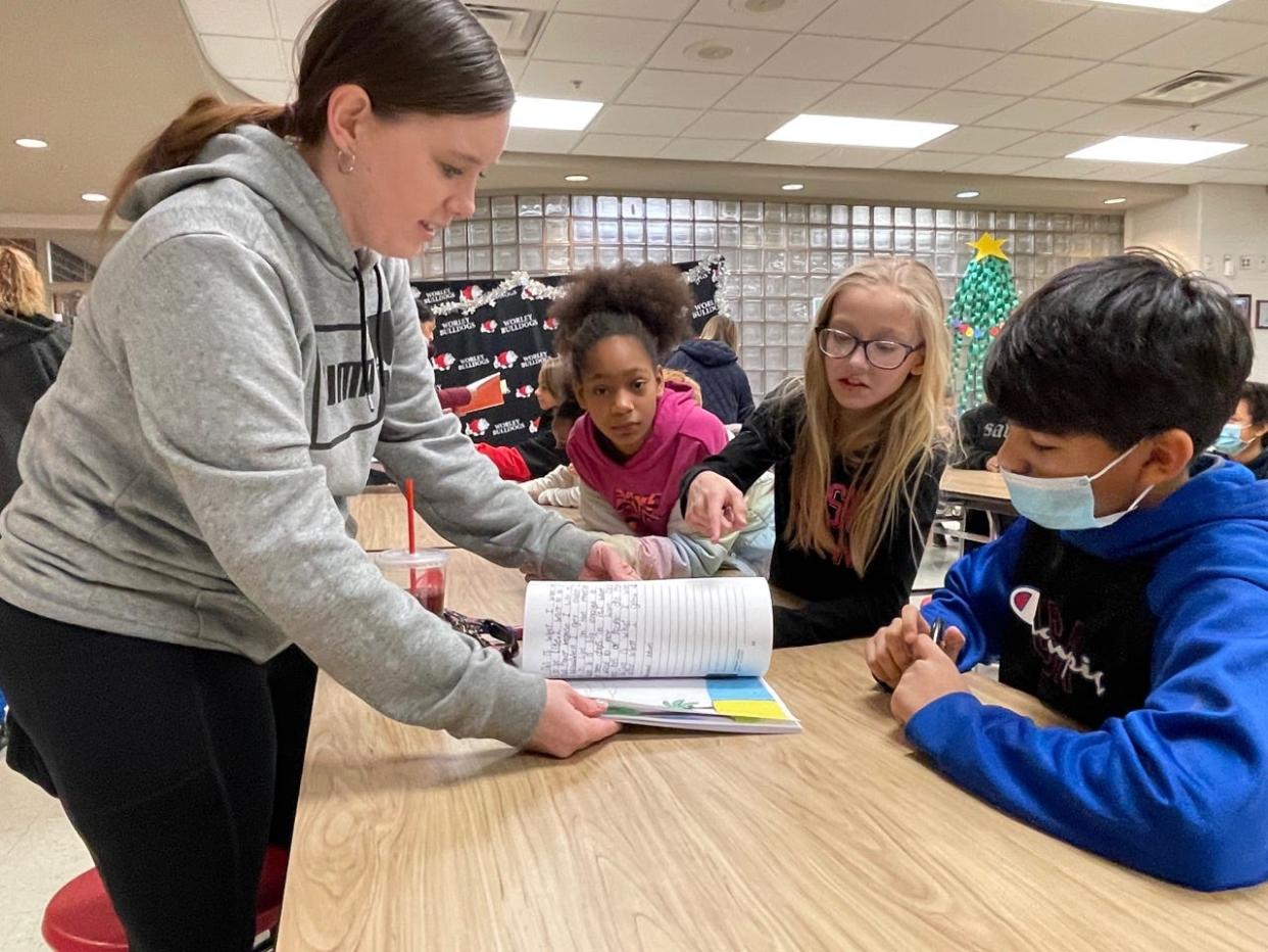 Worley School students Desmiree Hardeman, Kyleigh Hillery and Josthin Lopez-Cruz look over their new book "When I Grow Up." Fourth and fifth grade students wrote, illustrated and published their own book, which they signed for parents.
(Photo: Canton City Schools)