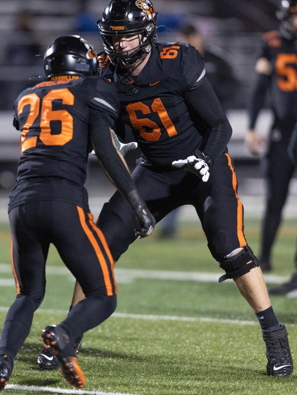 Massillon offensive tackle Nolan Davenport (61) gets loose ahead of a playoff game against Lake, Friday, Nov. 10, 2023.
