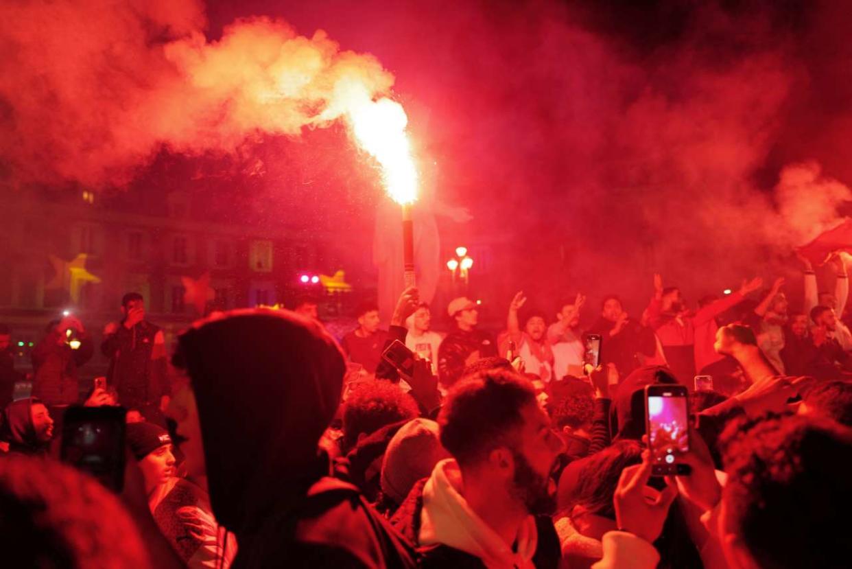 Morocco's supporters light smoke flares as they celebrate after their team won the Qatar 2022 World Cup round of 16 football match between Morocco and Spain, in Nice, southern France, on December 6, 2022. (Photo by Valery HACHE / AFP)