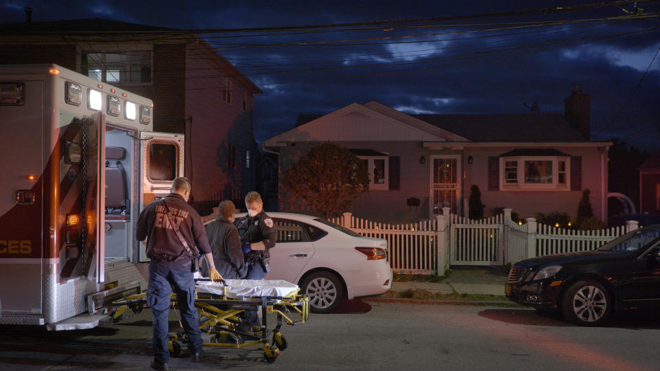 A patient with suspected symptoms of COVID-19 is put in an ambulance by EMT's in Yonkers, N.Y., on May 4, 2020. (Ed Ou / NBC News)