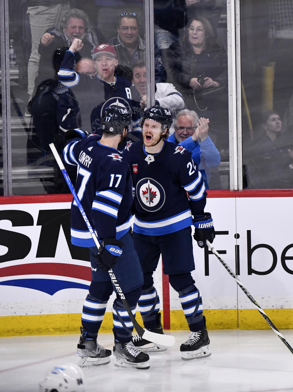 Winnipeg Jets' Mason Appleton celebrates his goal against the San Jose Sharks with Adam Lowry (17) during the third period of an NHL hockey game in Winnipeg, Manitoba, on Monday April 10, 2023. (Fred Greenslade/The Canadian Press via AP)