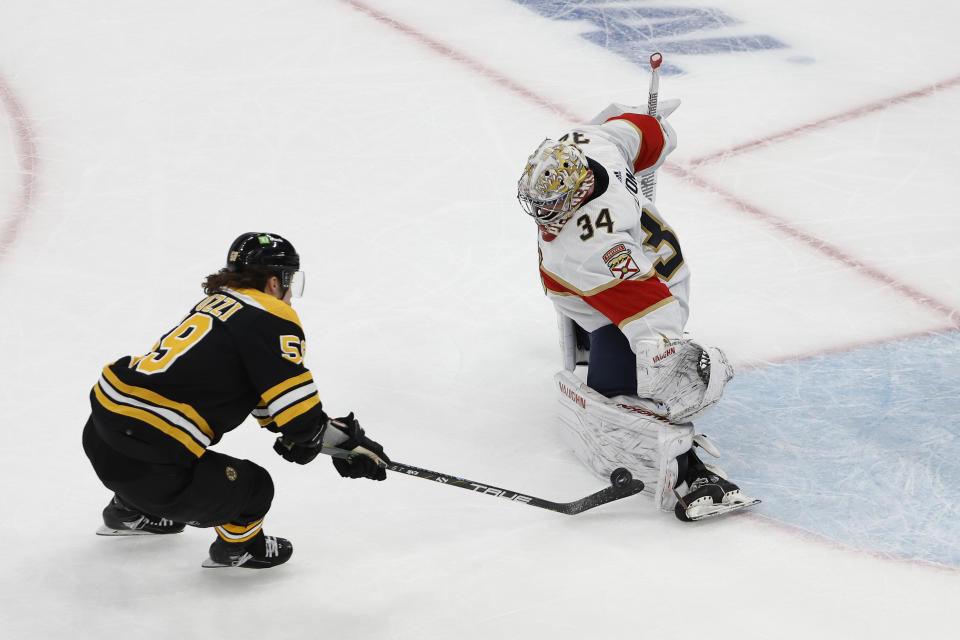 Florida Panthers goaltender Alex Lyon, right, makes a save as Boston Bruins' Tyler Bertuzzi tries to deflect it past him during the first period of Game 1 of an NHL hockey playoff series Monday, April 17, 2023, in Boston. (AP Photo/Winslow Townson)