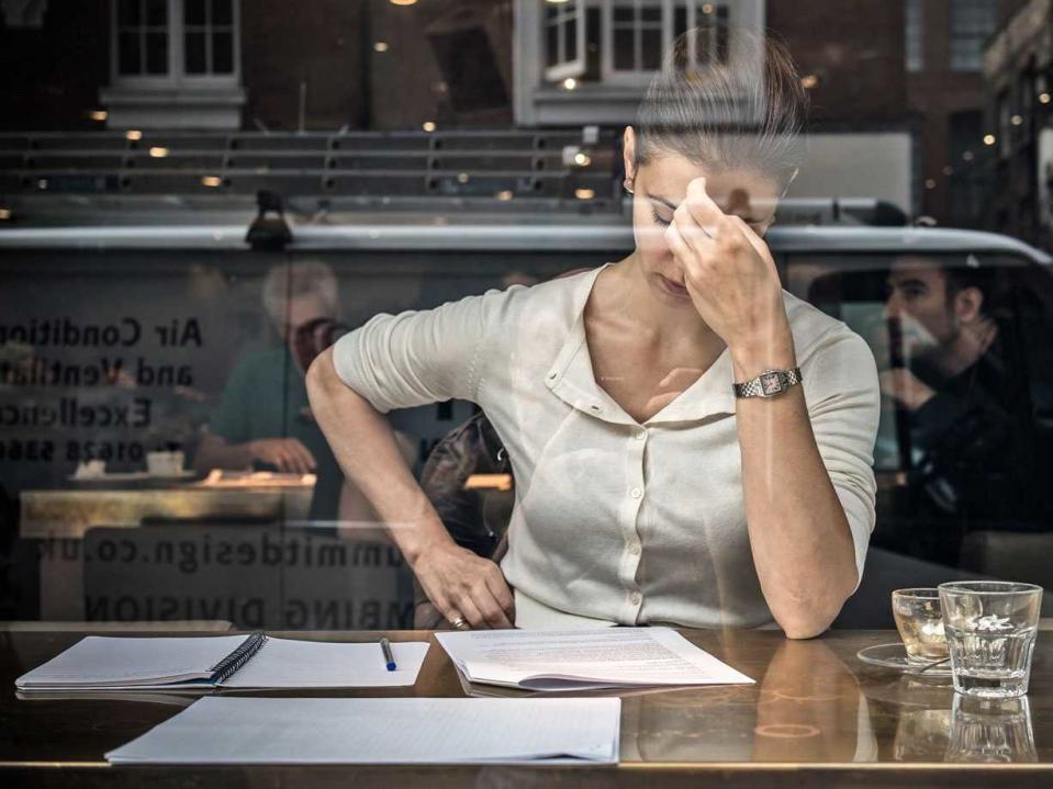 woman and papers stressed