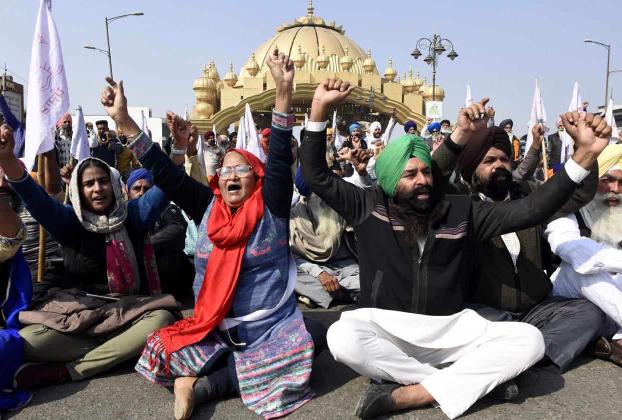 <span class="caption">Indian farmers hold a protest on the outskirts of Amritsar in the northern state of Punjab.</span> <span class="attribution"><a class="link " href="https://www.gettyimages.com/detail/news-photo/farmers-shout-slogans-as-they-block-a-highway-during-their-news-photo/1230997831?adppopup=true" rel="nofollow noopener" target="_blank" data-ylk="slk:Narinder Nanu/AFP via Getty Images;elm:context_link;itc:0;sec:content-canvas">Narinder Nanu/AFP via Getty Images</a></span>