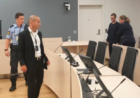 Philip Manshaus, who is suspected of an armed attack at Al-Noor Islamic Centre Mosque and killing his stepsister is escorted into a courtroom in Oslo