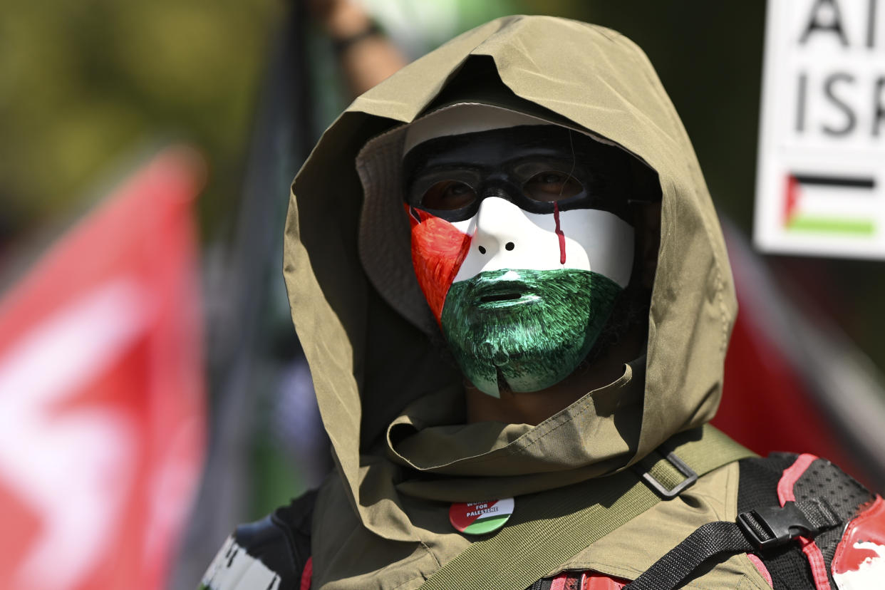 A protester wearing red, white and green face paint marches.