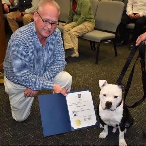 <p>Hopkinsville Police Department</p> Hopkinsville’s mayor, James R. Knight Jr., with Bolo after swearing the dog in as a "paw-trol officer".