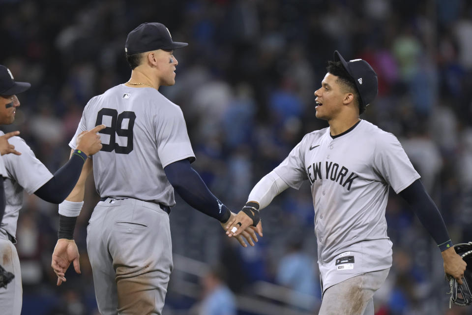 New York Yankees Aaron Judge (99) and Juan Soto celebrate the team's win over Toronto Blue Jays in a baseball game Friday, June 28, 2024, in Toronto. (Chris Young/The Canadian Press via AP)