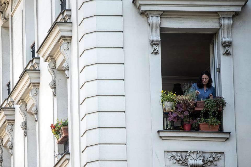 Nathalie Sartor, 57, tends her window boxes in her apartment in Montmartre, Paris, on May 31, 2021. One of the last things she did before France first locked down in March 2020 against the coronavirus pandemic was to rush out and buy soil and seeds for the window gardens that she lovingly tended during the months sealed away. "I seeded my flowers. They grew. It was a huge pleasure," she says. (AP Photo/ Joao Luiz Bulcao)