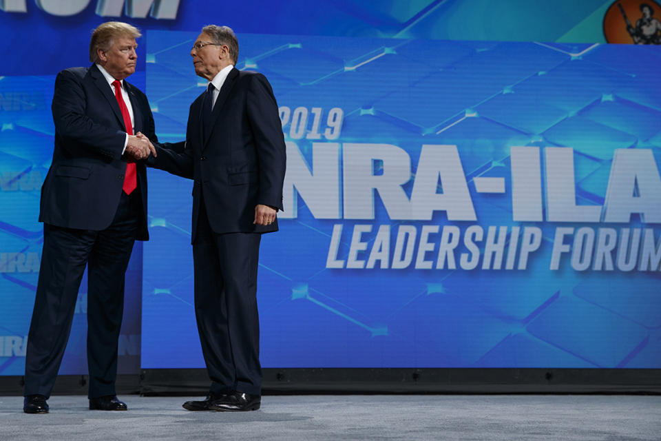President Donald Trump shakes hands with NRA executive vice president and CEO Wayne LaPierre as he arrives to speak to the annual meeting of the National Rifle Association, Friday, April 26, 2019, in Indianapolis. (AP Photo/Evan Vucci)